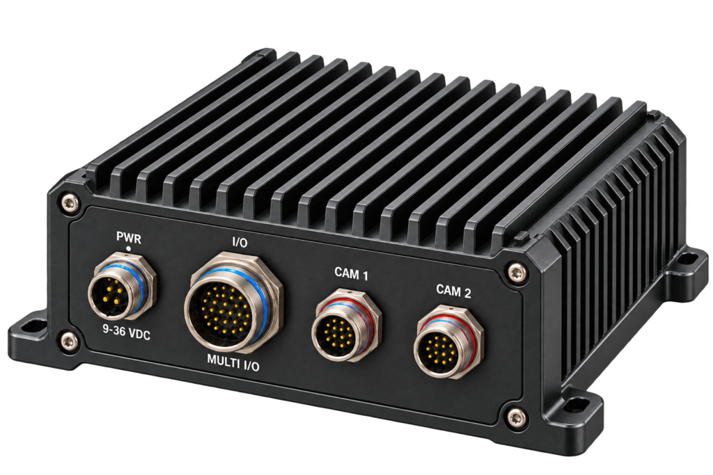 Rugged black industrial enclosure with heat sink fins and four circular connectors labeled PWR, I/O, CAM 1, and CAM 2 on the front panel.